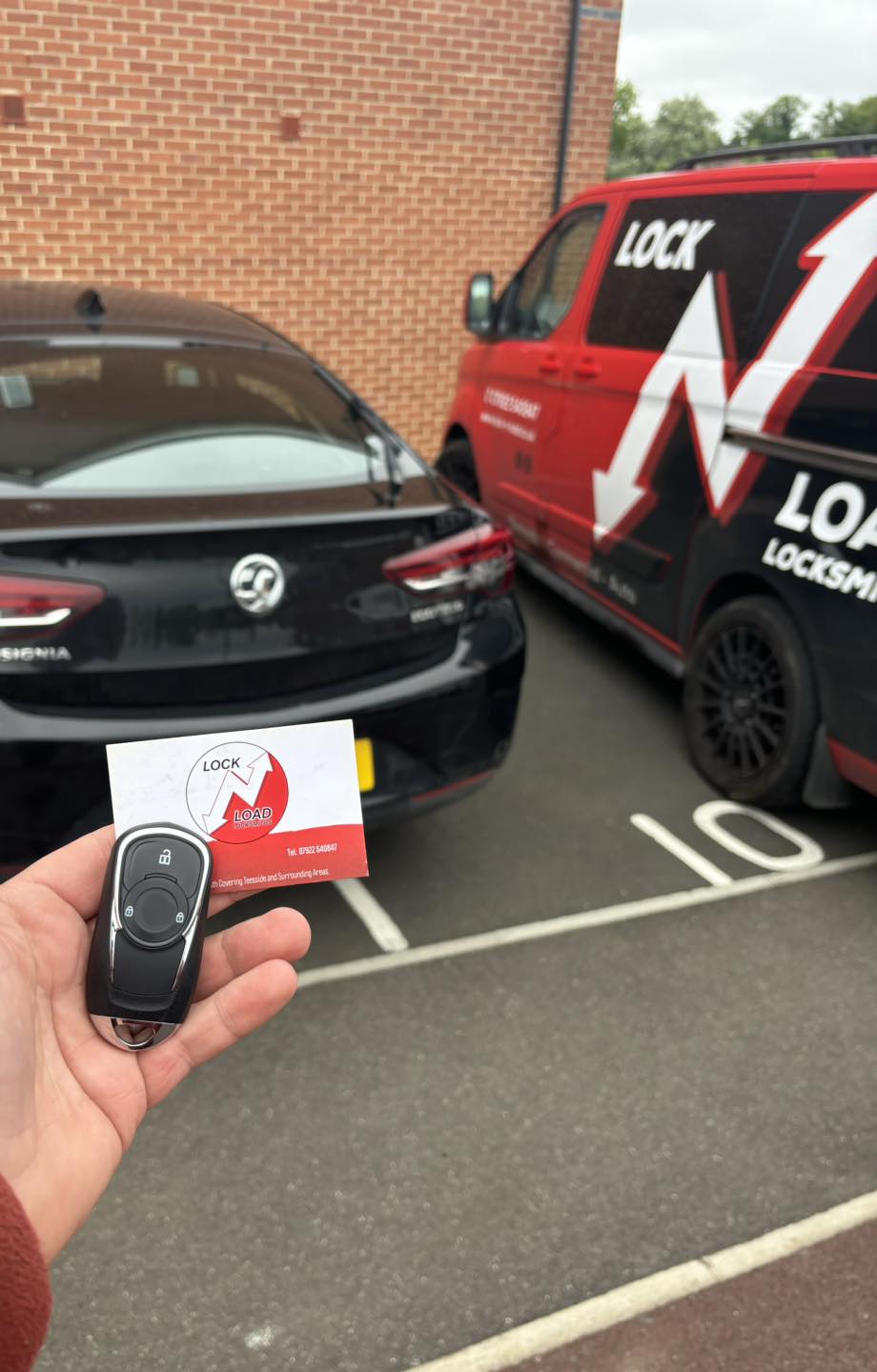 Replacement Volkswagen car key beside a Lock N Load van